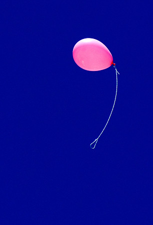 Flying pink balloon
